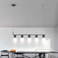 A 5 head Modern Black Pendant light mounted to the ceiling in an indoor setting